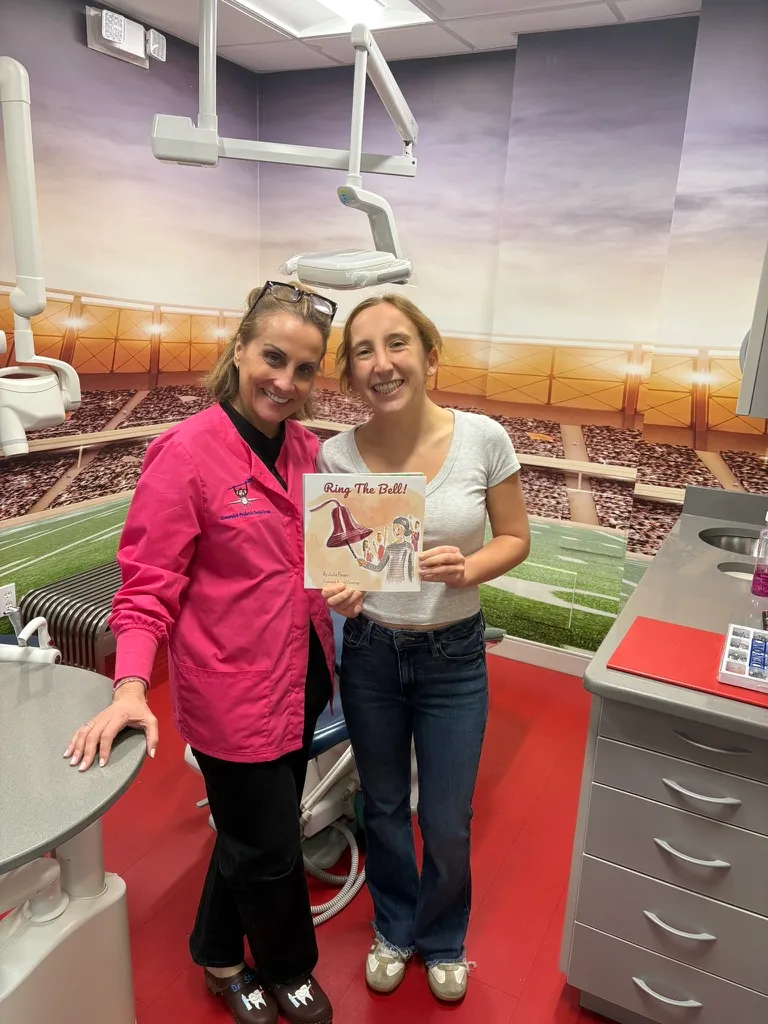Dr. Stacy at Greenwich Pediatric Dental Group with the Ring the Bell! book