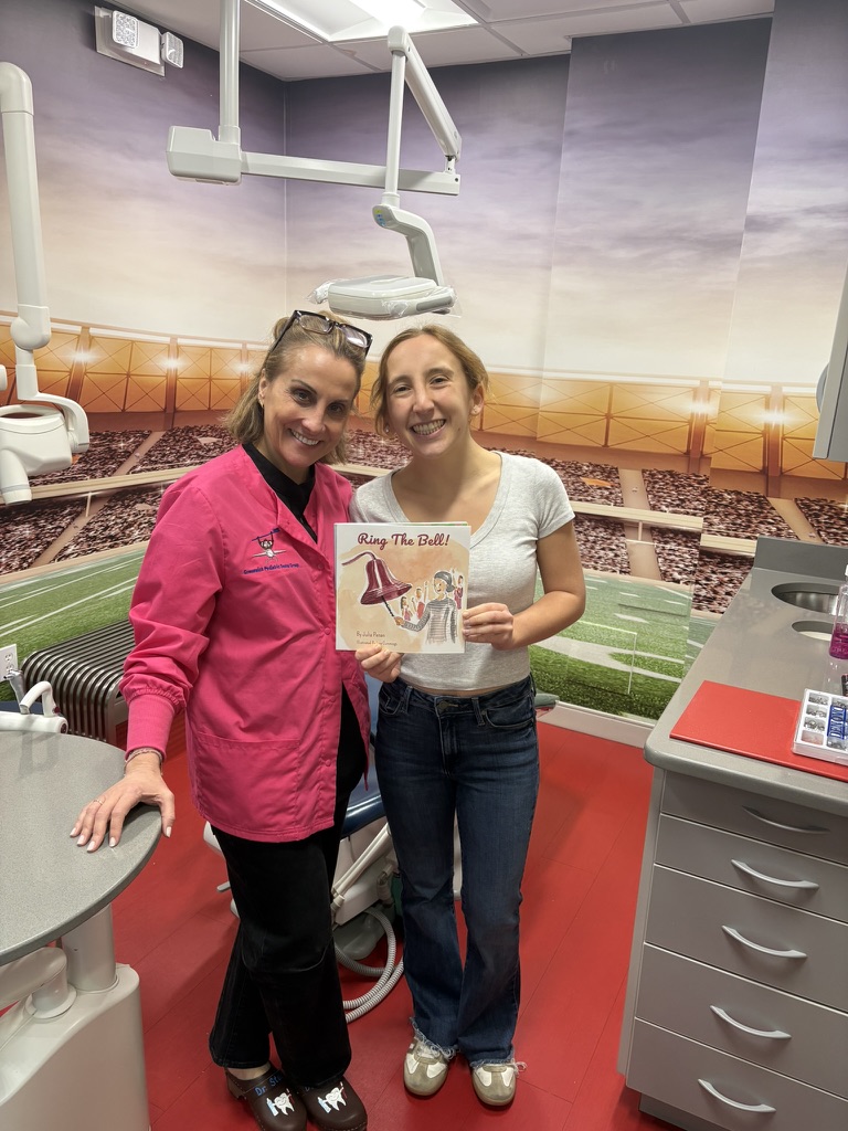 Dr. Stacy at Greenwich Pediatric Dental Group with the Ring the Bell! book